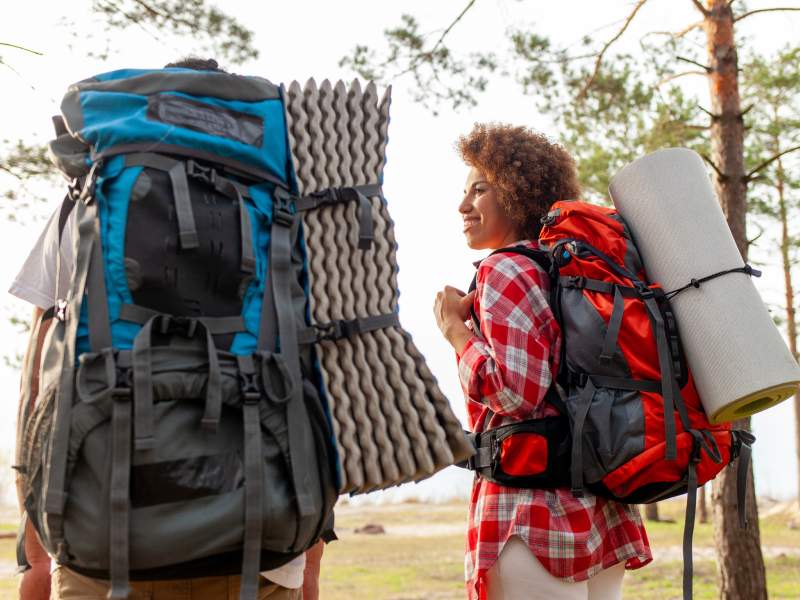 two people hiking with gear