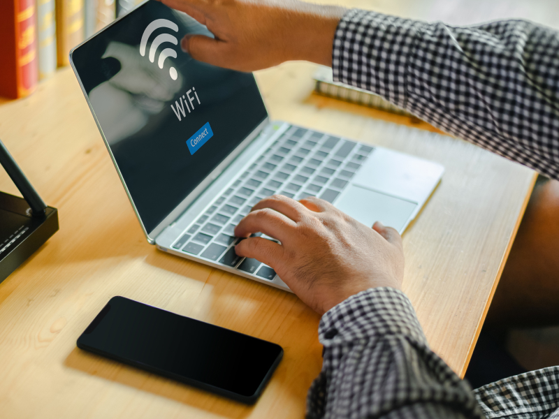 a laptop monitor with a wifi icon on the screen